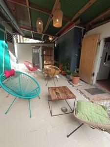 a patio with chairs and tables and a table at Ma case créole in Port-Louis +16 photos