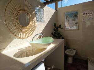a bathroom with a bowl sink on a counter at Ma case créole in Port-Louis