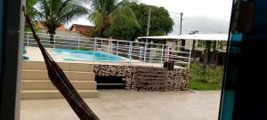 a view of a swimming pool from a house at Casa condomínio clube in Araruama
