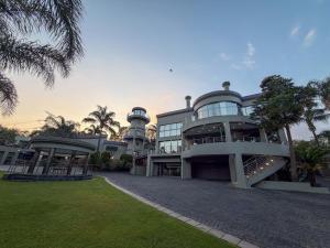 a large building with a staircase in front of it at Silva Villa in Bedfordview