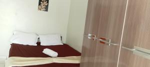 a bedroom with a bed and a wooden door at Casa condomínio clube in Araruama +18 photos
