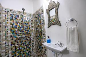 a bathroom with a shower and a sink and a mirror at Dar El Kendil in Fez +16 photos