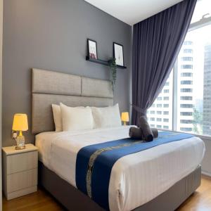 a bedroom with a large bed with a large window at Vortex Apartment klcc by HouseFull in Kuala Lumpur +47 photos