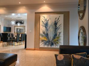 a living room with a large painting on the wall at Silva Villa in Bedfordview