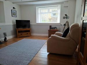 a living room with a couch and a television at Thurlestone House in St Ives +35 photos