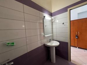a bathroom with a sink and a mirror at Hotel Prinos in Himare