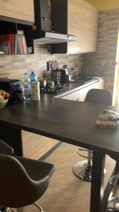 a kitchen with a black counter top and a stove at Sabry house in Novi Ligure +1 photo