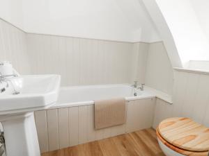 a bathroom with a sink and a toilet at Long Barn in Bridport +53 photos