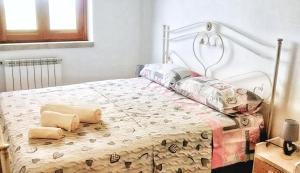 a bedroom with a bed with a metal headboard and pillows at Macari Villa Laura in Macari