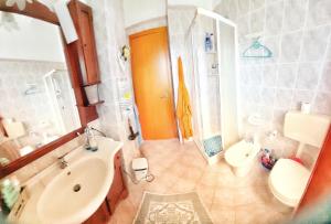 a bathroom with a sink and a toilet and a tub at Macari Villa Laura in Macari +28 photos
