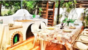 a patio with a table and a pizza oven at Macari Villa Laura in Macari