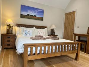 a bedroom with a bed with two towels on it at Heron's Hideaway in Wells next the Sea