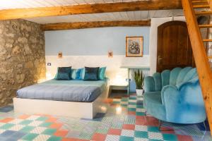 a bedroom with a bed and a chair at CollinaBlu in Torre San Severo +139 photos