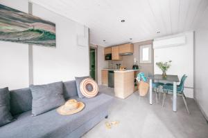a living room with a blue couch and a table at Camping LANDAE in Ondres