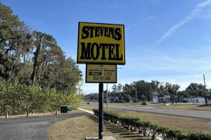 a sign for a motel on the side of a road at Stevens Motel by Capital O Ocala US 27 in Ocala