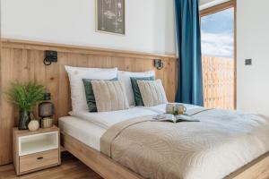 a bedroom with a bed with a book on it at Apres Ski Bachleda in Zakopane