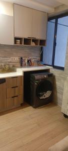 a kitchen with a dishwasher in the middle of a kitchen at Hillary homes in Nairobi