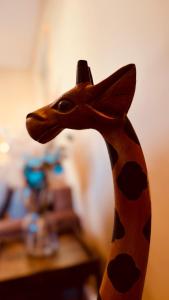 a wooden giraffe figurine on top of a table at Fabians Ferienhaus Rursee Rusti in Simmerath