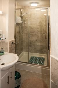 a bathroom with a shower and a sink at Belle View in Skegness