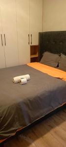 a bedroom with a bed with two towels on it at Hillary homes in Nairobi +8 photos