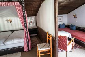 a bedroom with two bunk beds and a table at Berghotel Blaickner's Sonnalm in Zell am See