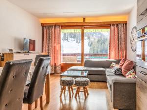 a living room with a couch and a table at Apartment Rosablanche D31 by Interhome in Siviez