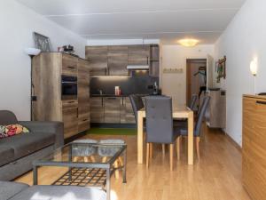 a living room with a table and a kitchen at Apartment Rosablanche D31 by Interhome in Siviez +15 photos