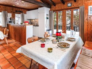 a dining room with a table with plates of food on it at Chalet Sven Heul by Interhome in Nendaz