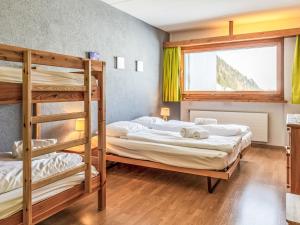 two bunk beds in a room with a window at Apartment Rosablanche D31 by Interhome in Siviez