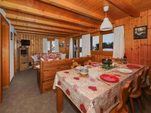 a dining room with a table with red dishes on it at Chalet Coucordin by Interhome in Nendaz