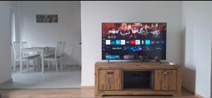 a flat screen tv sitting on top of a wooden entertainment center at Smit apartman in Novi Vinodolski