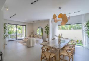 a living room with a table and chairs at Villa Mansour in Abu Dhabi