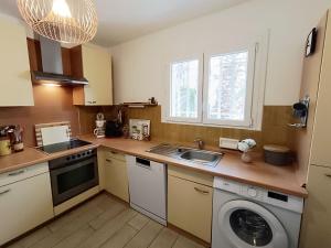 a kitchen with a sink and a washing machine at Holiday Home Les Troenes by Interhome in Fréjus +29 photos