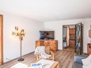 a living room with a tv and a couch at Apartment Chesa Clüs 6 by Interhome in Zuoz