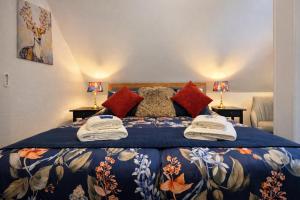 a bedroom with a large bed with a blue blanket at Hotel Wappenhof in Braunlage
