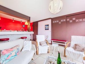 a living room with white furniture and red walls at Holiday Home Gevanac by Interhome in Crozon