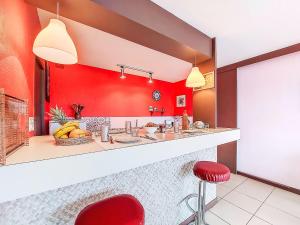 a restaurant with red walls and red stools at Holiday Home Gevanac by Interhome in Crozon +22 photos