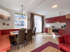 a kitchen and living room with a table and chairs at Apartment Lechners Wohnwelt-2 by Interhome in Stumm +25 photos