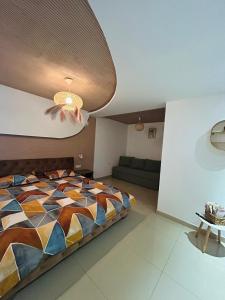 a bedroom with a bed and a ceiling at Hobbitul lui Maș in Valea lui Maş