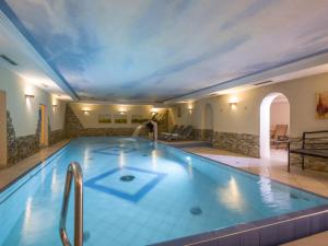 a swimming pool in a hotel with a ceiling at Apartment Lechners Wohnwelt-2 by Interhome in Stumm