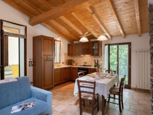 a living room with a table and a blue couch at Holiday Home Ca' da Ciassa - Prima Porta - VLO132 by Interhome in Pantasina