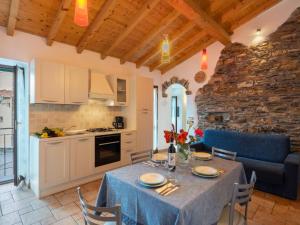 a kitchen and dining room with a table and chairs at Holiday Home Ca' da Ciassa - Prima Porta - VLO132 by Interhome in Pantasina