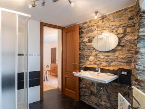 a bathroom with a stone wall and a sink at Holiday Home Ca' da Ciassa - Prima Porta - VLO132 by Interhome in Pantasina +90 photos
