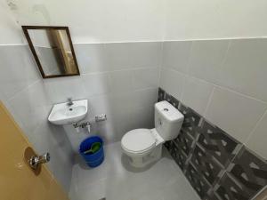 a small bathroom with a toilet and a sink at Belga Boarding House in Guimaras +8 photos