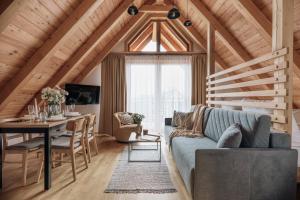 a living room with a blue couch and a table at Apres Ski Bachleda in Zakopane