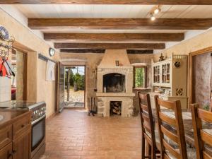 a kitchen with a fireplace and a table and chairs at Holiday Home Tomiceva by Interhome in Gornja Klada