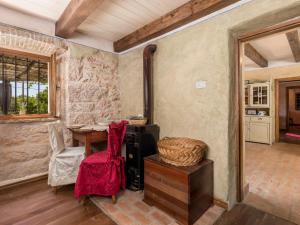 a living room with a table and a chair at Holiday Home Tomiceva by Interhome in Gornja Klada