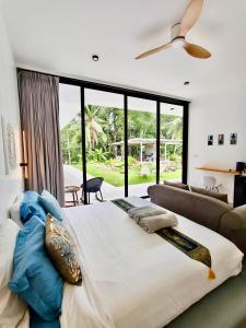 a bedroom with a large bed and a couch at Villa harmony haven in Taling Ngam in Ban Khok Kroat +55 photos