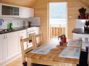 a kitchen with a wooden table in a cabin at Apartment Vardeheii by Interhome in Arnefjord