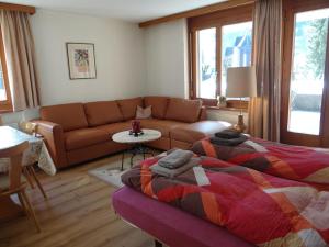 a living room with a bed and a couch at Apartment Blumenweg 6 by Interhome in Engelberg